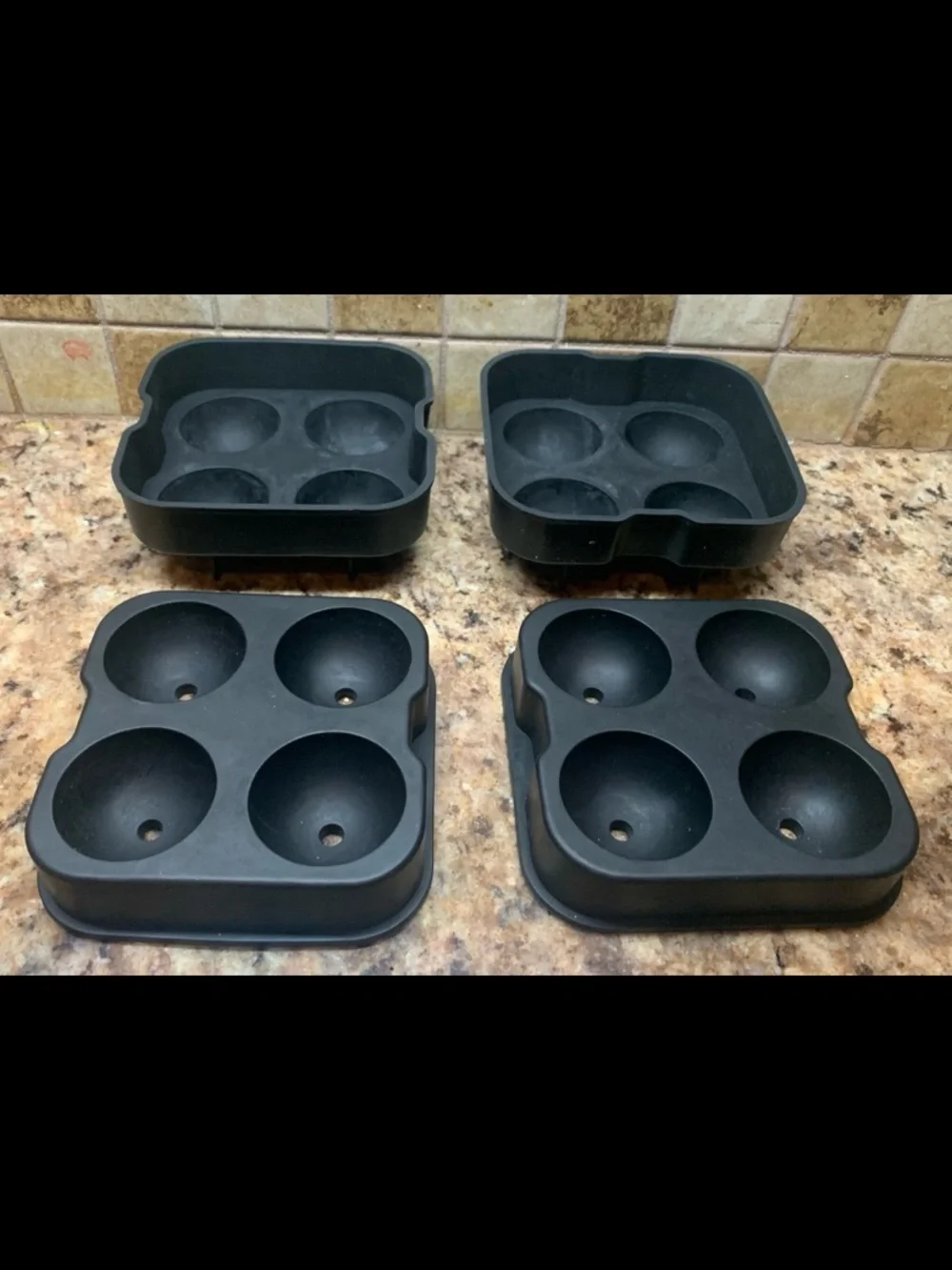 Four-hole silicone ice ball maker (2) trays with lids.